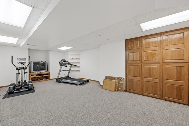 workout area with a drop ceiling and carpet flooring