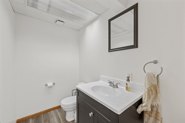 bathroom featuring hardwood / wood-style flooring, vanity, and toilet