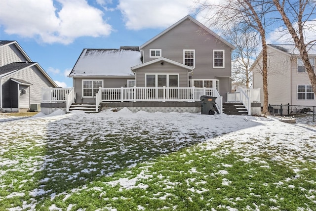 snow covered property featuring a wooden deck