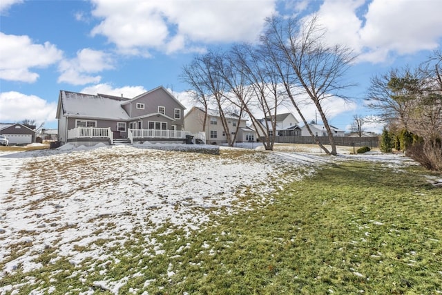 snow covered back of property with a yard