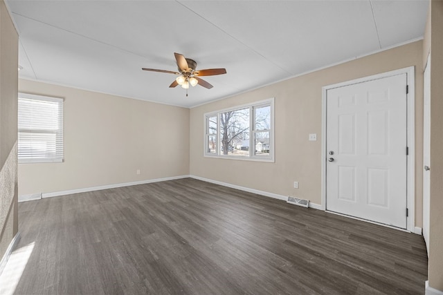 interior space with dark hardwood / wood-style flooring, ceiling fan, ornamental molding, and a healthy amount of sunlight