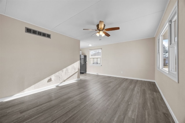 unfurnished room featuring ceiling fan and dark hardwood / wood-style flooring