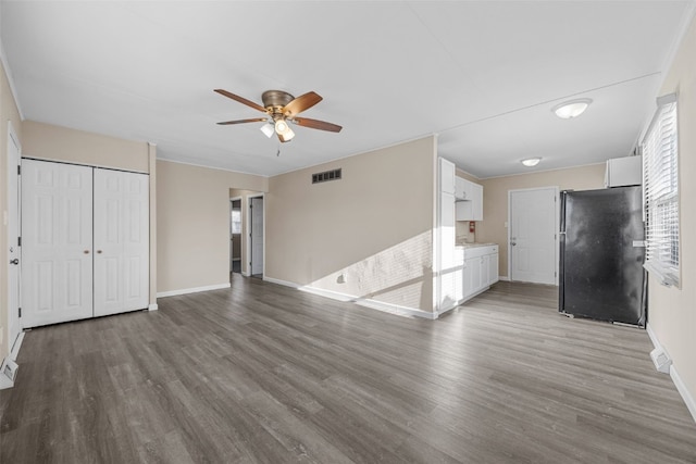 unfurnished living room with ceiling fan and hardwood / wood-style floors