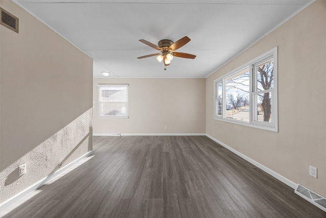 unfurnished room with ceiling fan, plenty of natural light, dark hardwood / wood-style floors, and ornamental molding