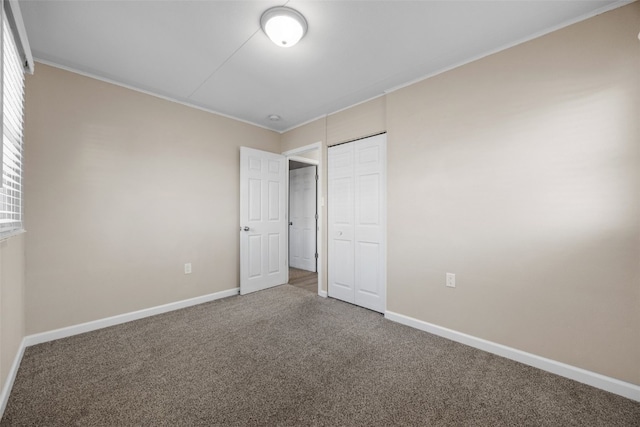 unfurnished bedroom with carpet floors and a closet