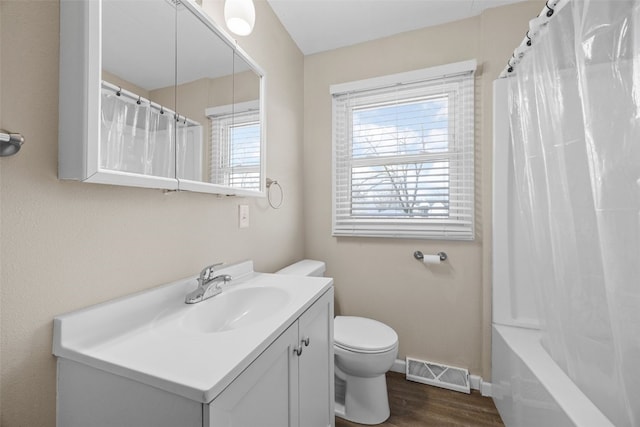 full bathroom featuring shower / bathtub combination with curtain, vanity, toilet, and hardwood / wood-style floors