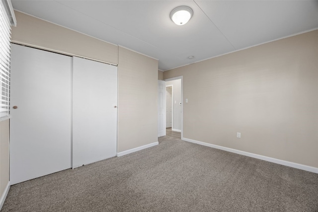 unfurnished bedroom featuring carpet floors and a closet