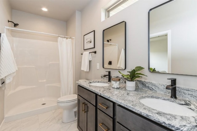 bathroom with vanity, toilet, and curtained shower