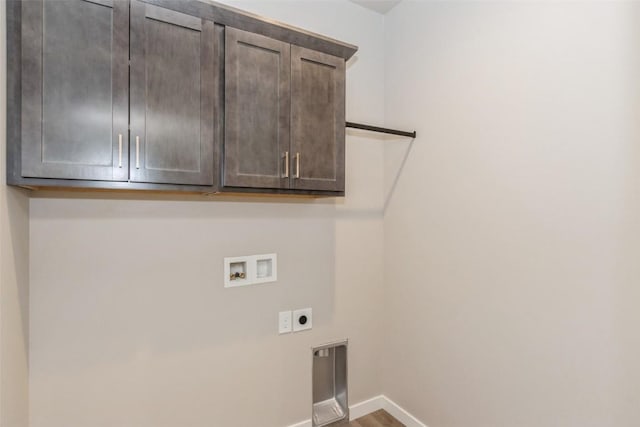 laundry room featuring hookup for a washing machine, electric dryer hookup, hardwood / wood-style floors, and cabinets