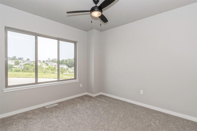 empty room featuring carpet and ceiling fan