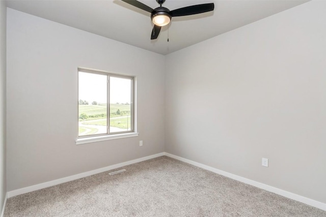 empty room featuring carpet floors and ceiling fan