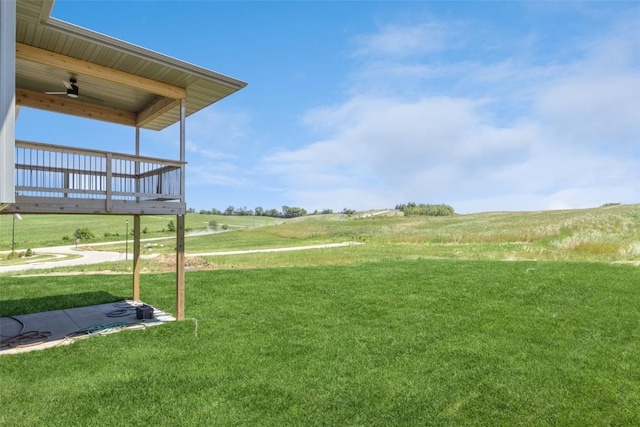 view of yard featuring a wooden deck and a rural view