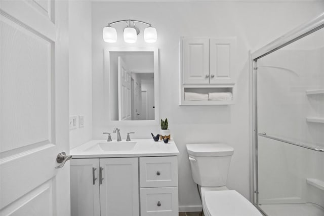 bathroom featuring walk in shower, vanity, and toilet