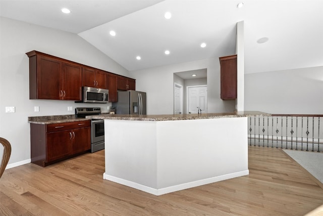 kitchen with lofted ceiling, sink, light hardwood / wood-style floors, and appliances with stainless steel finishes