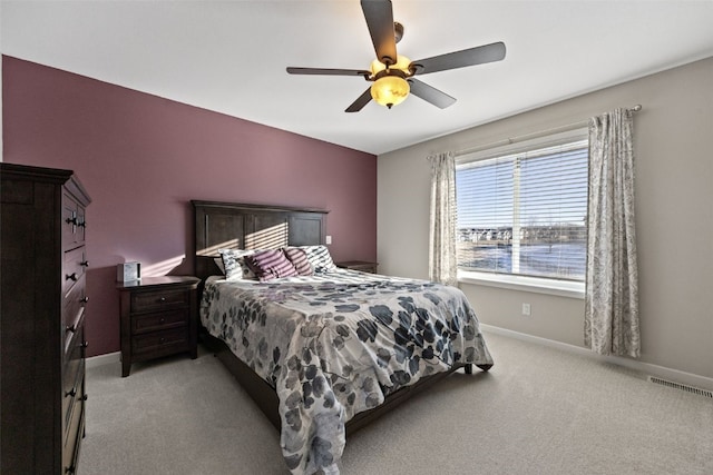 bedroom featuring light carpet and ceiling fan