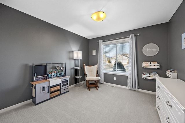 sitting room featuring light colored carpet