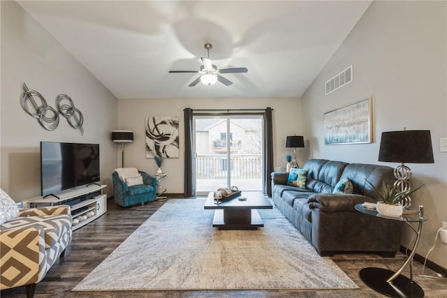 living room with lofted ceiling, dark wood-type flooring, and ceiling fan