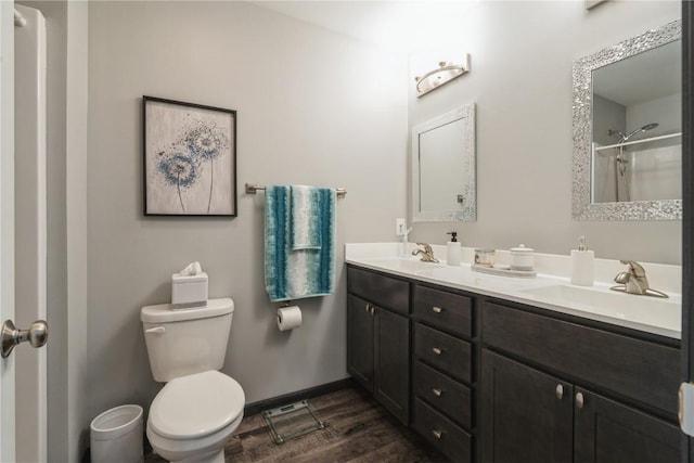 bathroom featuring walk in shower, vanity, toilet, and wood-type flooring