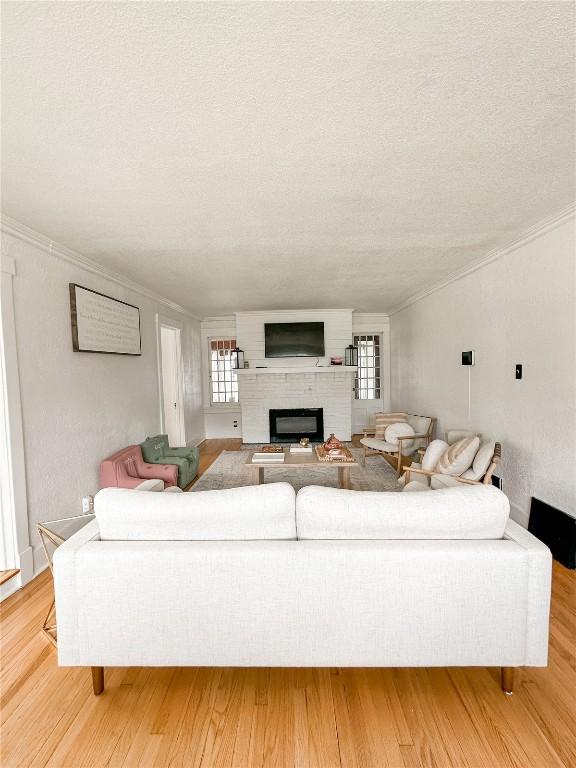 living room featuring light hardwood / wood-style floors and a textured ceiling