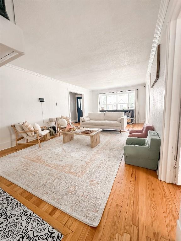 living room with crown molding and hardwood / wood-style floors