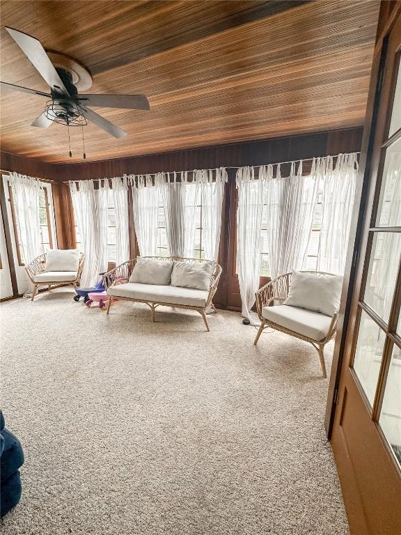 sunroom / solarium featuring wood ceiling and ceiling fan