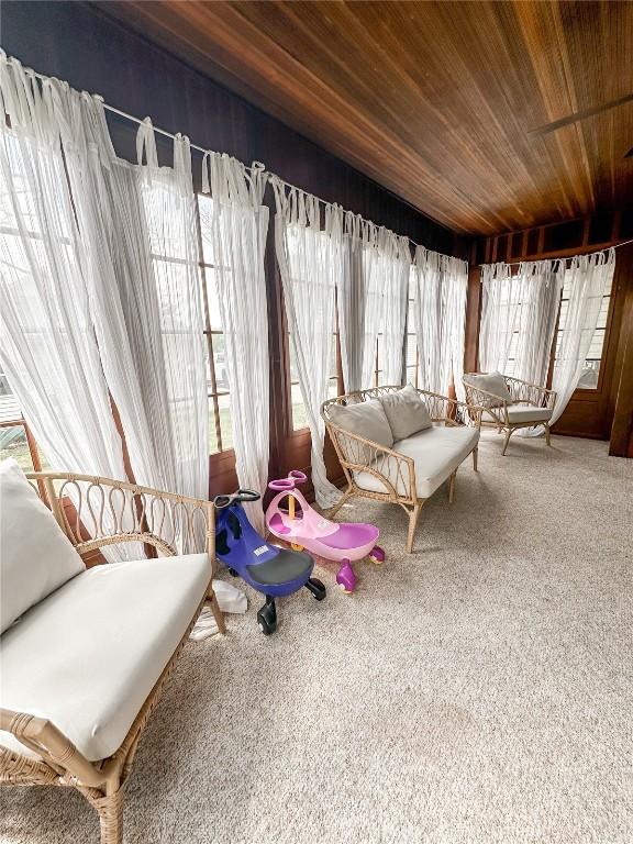 sunroom / solarium featuring wooden ceiling