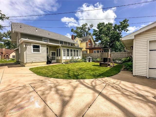 back of property featuring a yard and a patio area