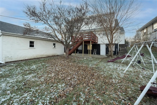 rear view of house with a playground and a patio area