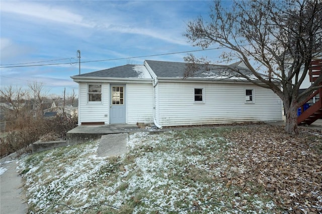 view of snow covered back of property