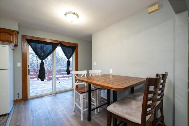 dining space featuring wood-type flooring