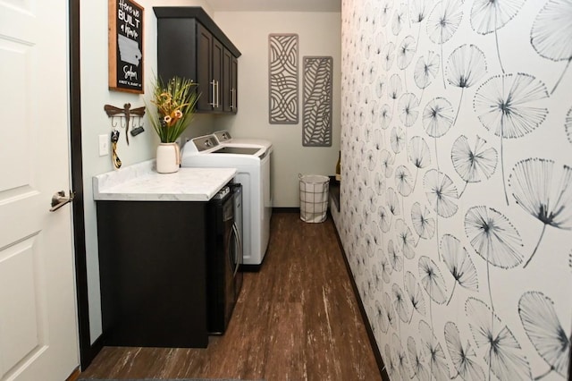 laundry area with cabinets, dark hardwood / wood-style flooring, and washer and clothes dryer