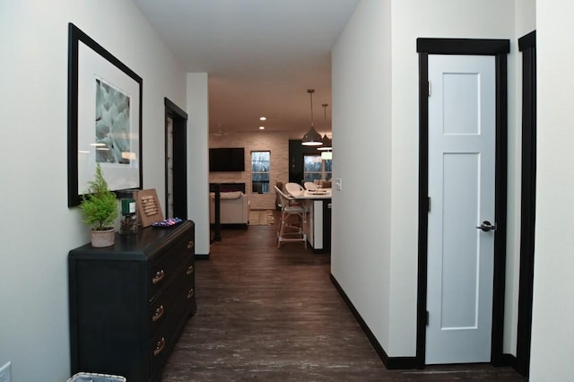 hallway with dark hardwood / wood-style flooring