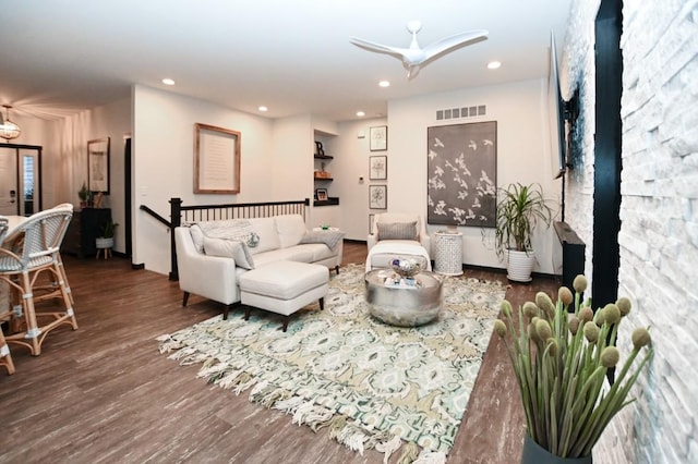 living room featuring dark hardwood / wood-style floors and ceiling fan