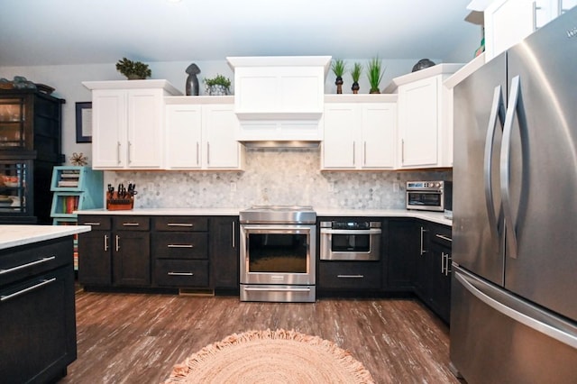 kitchen with white cabinetry, appliances with stainless steel finishes, dark wood-type flooring, and decorative backsplash