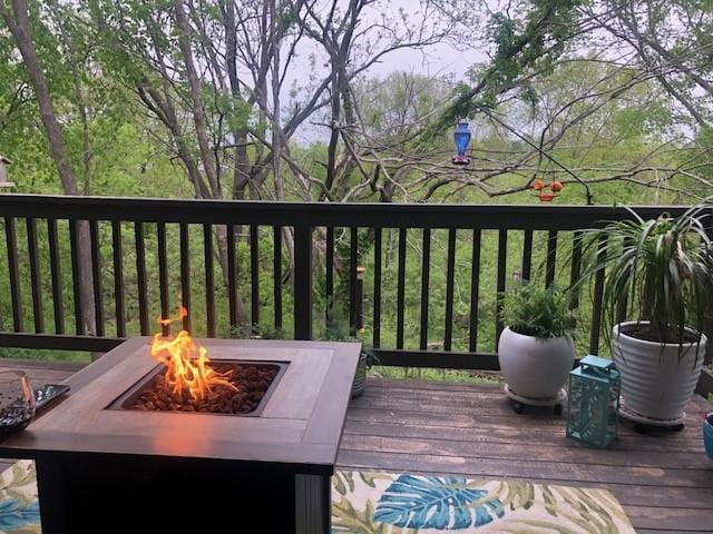 wooden deck featuring a fire pit