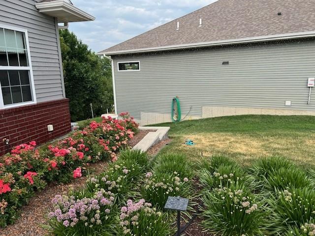 view of side of home featuring a lawn