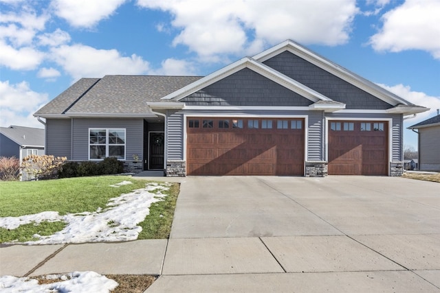 craftsman house featuring a garage and a front yard