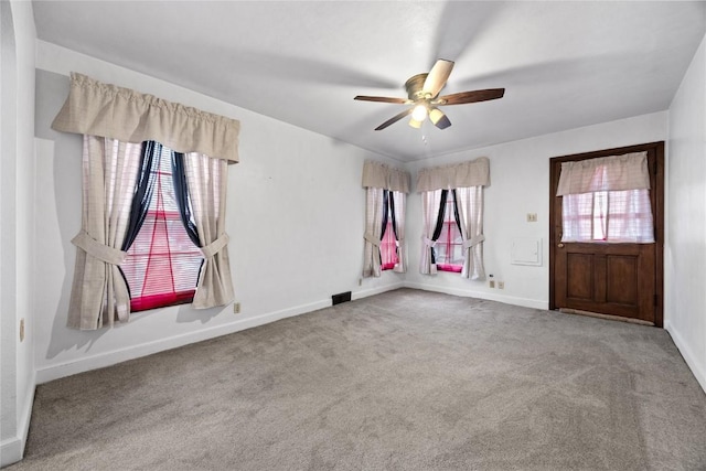 empty room featuring carpet floors and ceiling fan