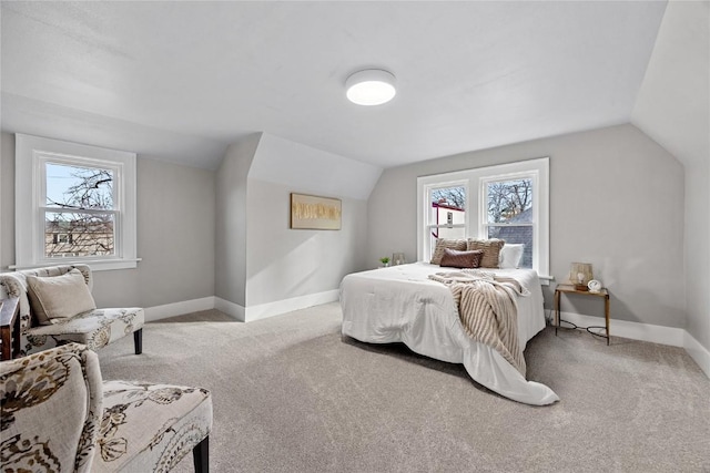 bedroom featuring light carpet and vaulted ceiling