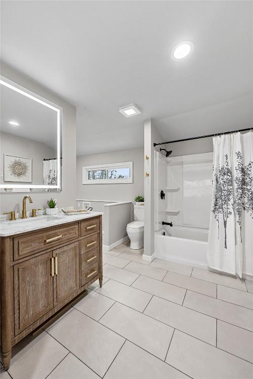 full bathroom with tile patterned floors, vanity, toilet, and shower / bath combo with shower curtain