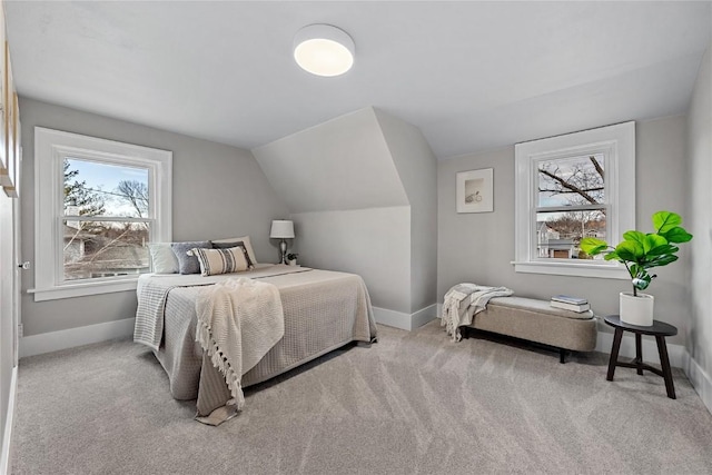 bedroom featuring lofted ceiling and light carpet