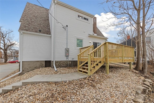 rear view of property featuring a deck