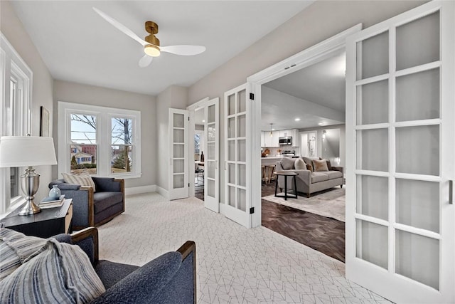 carpeted office space with french doors and ceiling fan