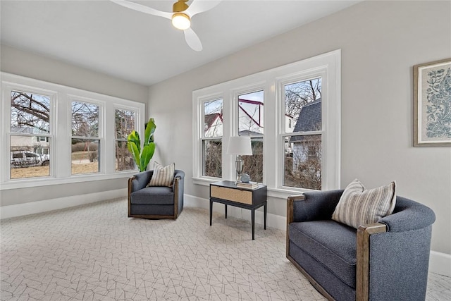 living area with light colored carpet and ceiling fan