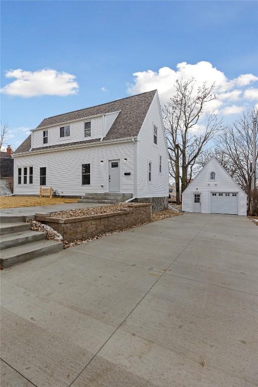 view of front facade with a garage and an outbuilding