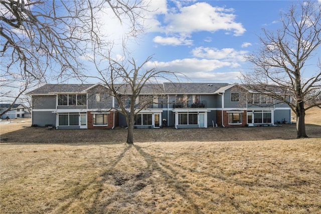 rear view of property with a lawn