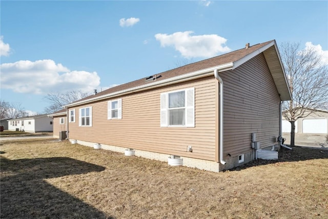 back of property with a yard and central AC