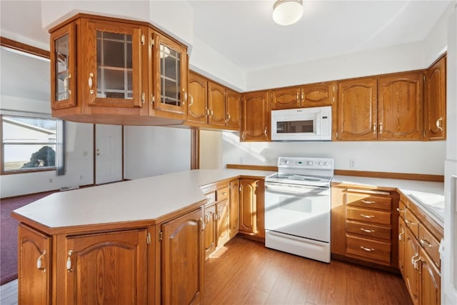 kitchen featuring light wood-type flooring and white appliances