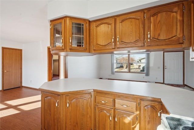 kitchen featuring kitchen peninsula and light hardwood / wood-style floors