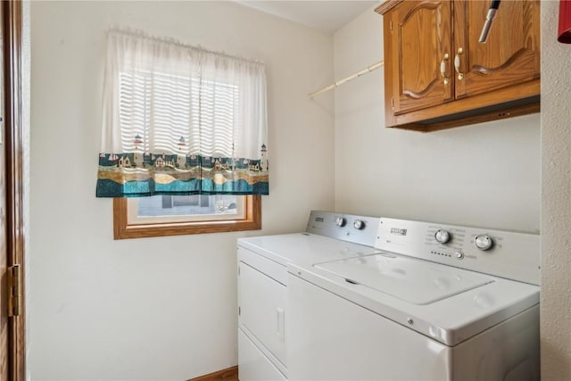 washroom with cabinets and washer / dryer